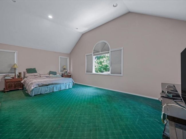 Bedroom featuring lofted ceiling, carpet flooring, baseboards, and recessed lighting | Image 18