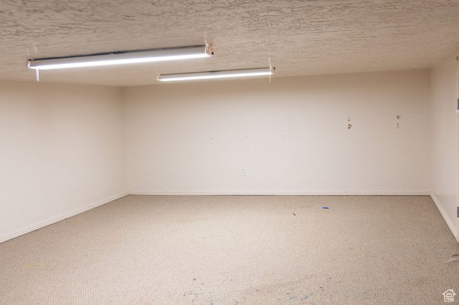 Kids play area or storage room with baseboards | Image 25