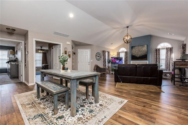 Dining space with dark wood-type flooring, lofted ceiling, and plenty of natural light | Image 4