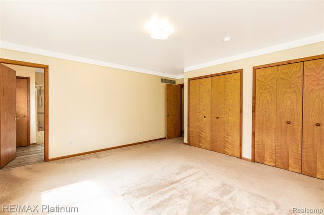 Two large master closets with the entrance to the Master Bath. | Image 23