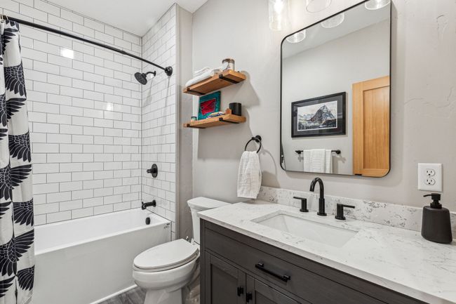 Full bathroom featuring vanity, shower / bath combo with shower curtain, toilet, and wood finished floors | Image 28