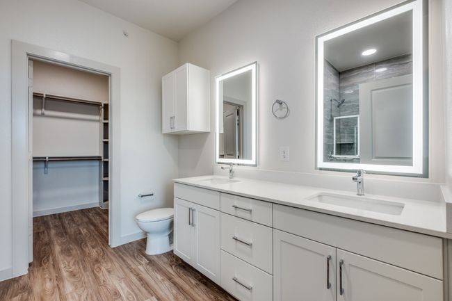 Bathroom with a tile shower, toilet, wood finished floors, and a sink | Image 9