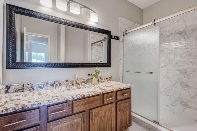 Bathroom featuring a stall shower and vanity | Image 20