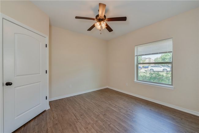 Unfurnished room with baseboards, wood finished floors, and ceiling fan | Image 7