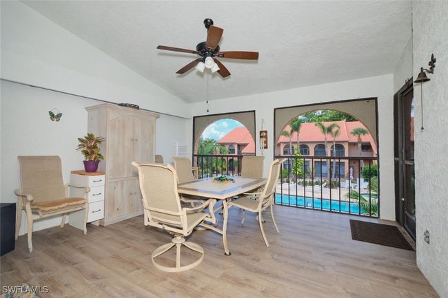 Dining room featuring a ceiling fan, light wood finished floors, a textured ceiling, and lofted ceiling | Image 4