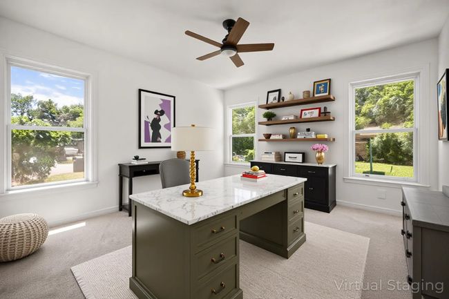 Office featuring light colored carpet, ceiling fan, and built in desk | Image 12
