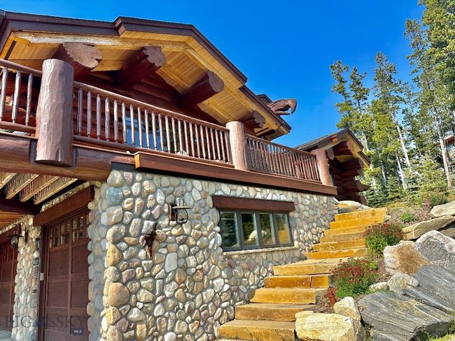 Summer exterior steps to deck and front entrance of home. | Image 92