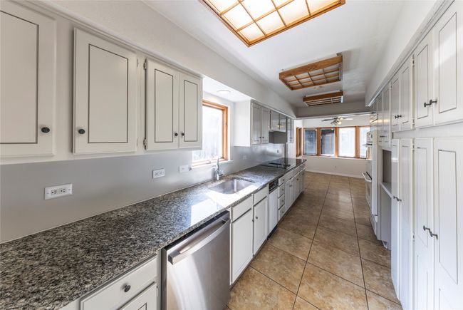 Kitchen provides significant cabinet storage space. | Image 10