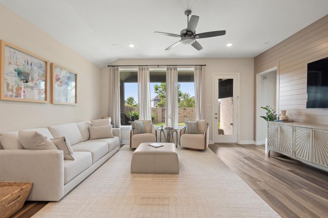 The living room with the wall of windows and beautiful upgraded shiplap wall offers a great area to entertain or gather with family and friends. | Image 13