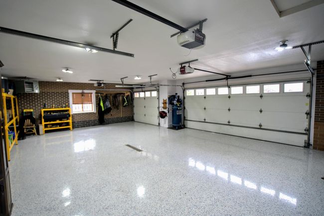 Epoxied garage floors w/in-floor heat, quiet close garage doors & a drive through 3rd stall | Image 25