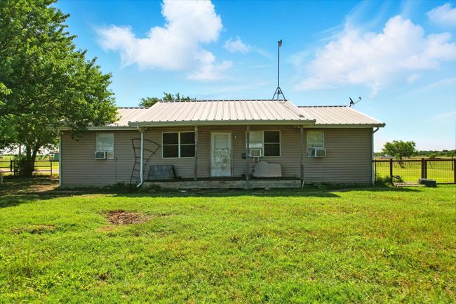 Back of house featuring cooling unit and a metal roof | Image 13