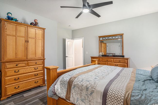 Bedroom featuring dark wood-style flooring and ceiling fan | Image 22