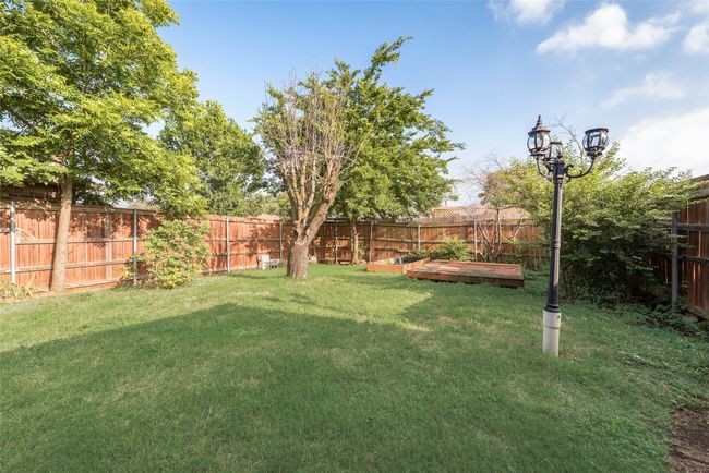 View of fenced backyard | Image 16