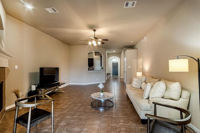 Spacious living room with a cozy fireplace, perfect for your furniture and gatherings. | Image 4