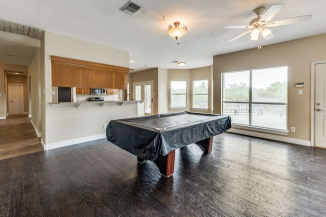 Recreation room featuring billiards, ceiling fan, wood-type flooring, baseboards, and visible vents | Image 14