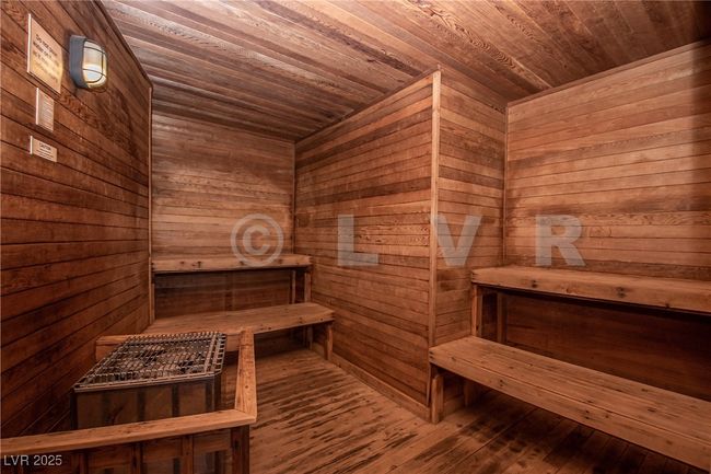 Sauna / steam room with wooden ceiling, wooden walls, and hardwood / wood-style flooring | Image 18