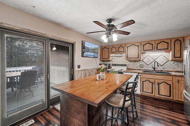 Walk out from the Kitchen to a beautiful deck overlooking the large yard. Perfect for grilling! | Image 6