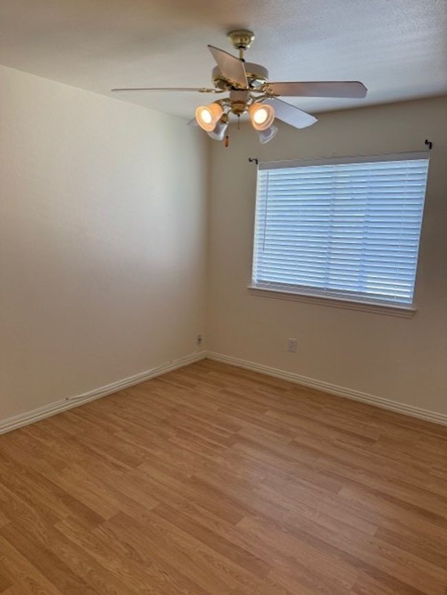 Spare room with light wood-type flooring and ceiling fan | Image 16