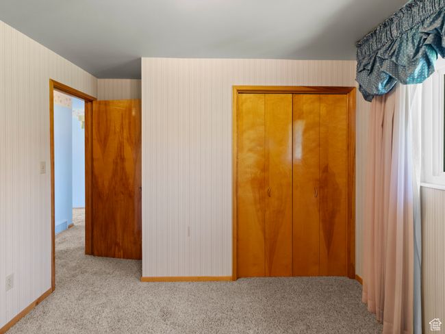 Unfurnished bedroom featuring carpet floors, a closet, and baseboards | Image 16