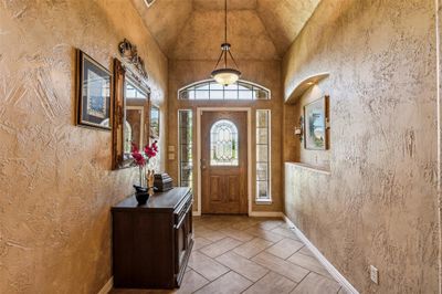 Tiled foyer featuring high vaulted ceiling | Image 3