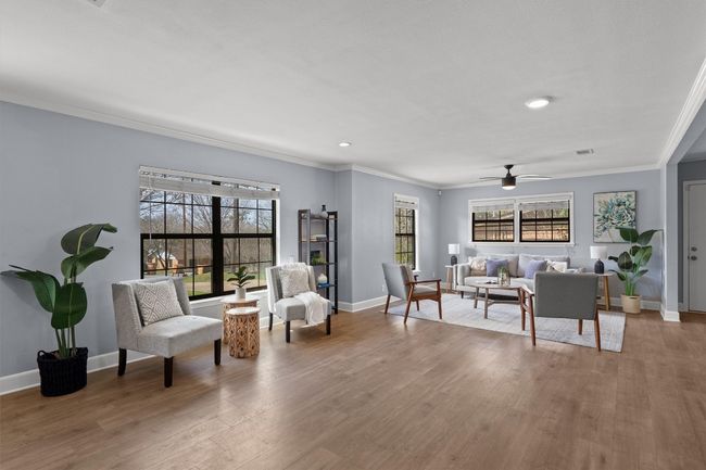 Living room featuring crown molding, baseboards, and wood finished floors | Image 8
