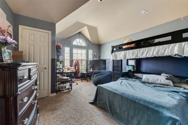 Bedroom with lofted ceiling and carpet flooring | Image 27