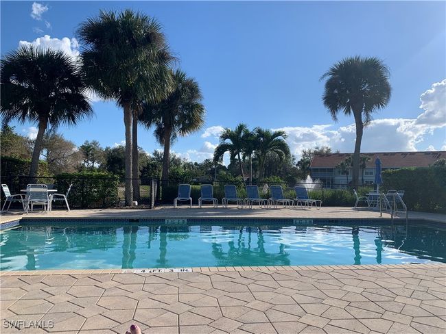 Community pool featuring fence and a patio area | Image 12