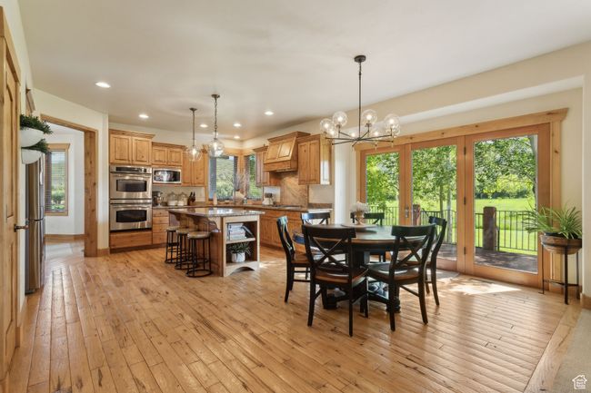 Dining space with a chandelier, recessed lighting, and light wood-style flooring | Image 14