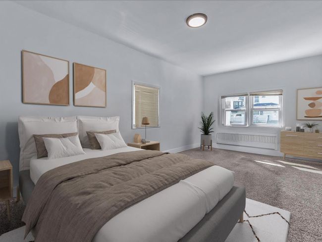 Bedroom featuring radiator heating unit and carpet floors | Image 16