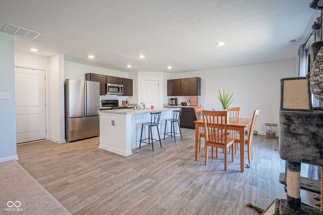 dining space with light wood finished floors and recessed lighting | Image 8