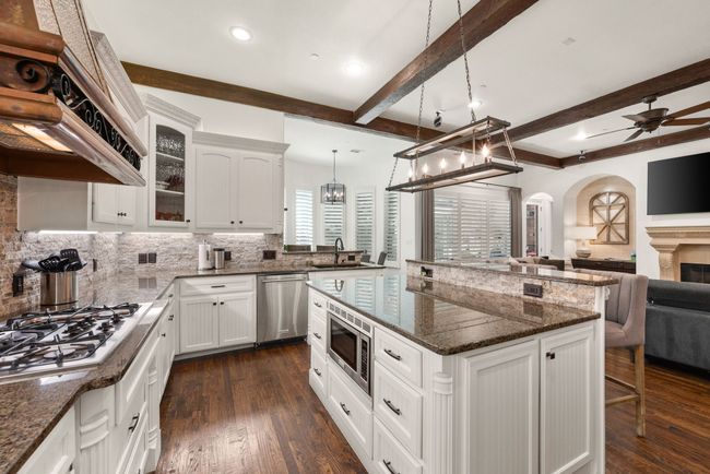Stainless steel appliances include a drawer microwave, lots of storage space and a combination island-breakfast bar. | Image 13