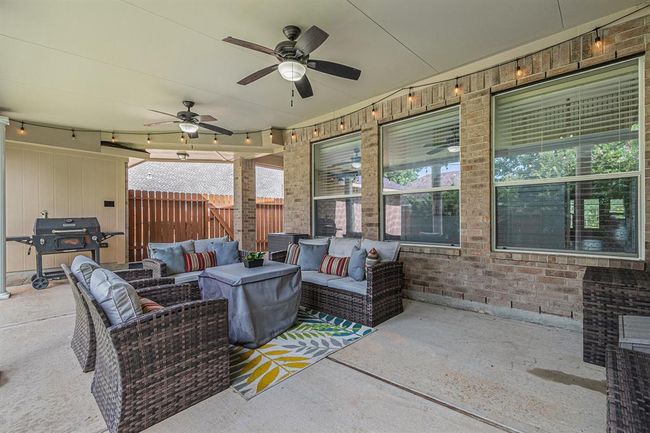 This angle shows you how spacious this covered patio is. Nights staying up, drinking a cool beverage and visiting with friends seems just like the ideal use of this space! | Image 38