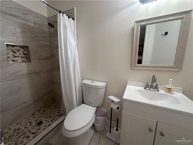 Bathroom featuring vanity, toilet, and walk in shower | Image 12