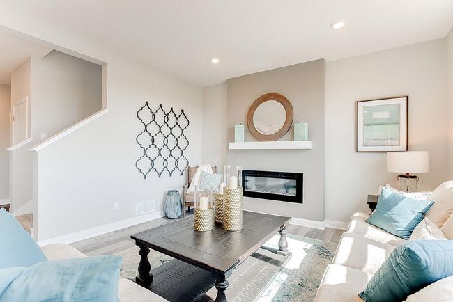 Welcome home! Enjoy the well lit living room with fireplace. Photo of model home, color & options will vary. | Image 7