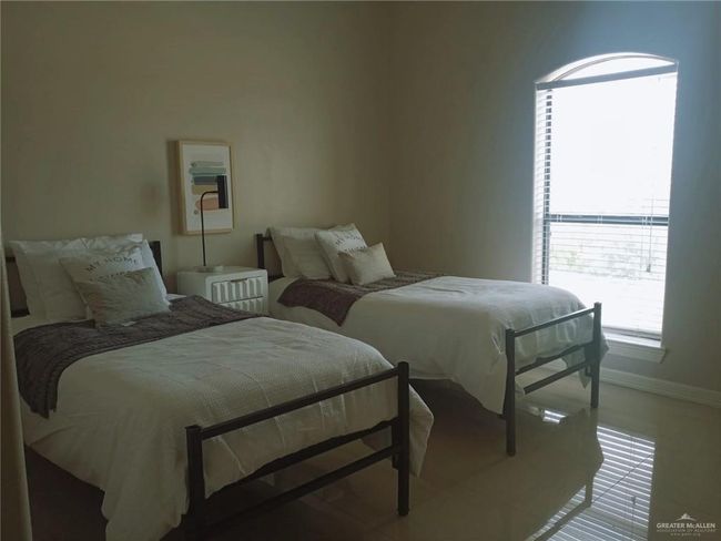 Bedroom with light tile patterned floors and baseboards | Image 7