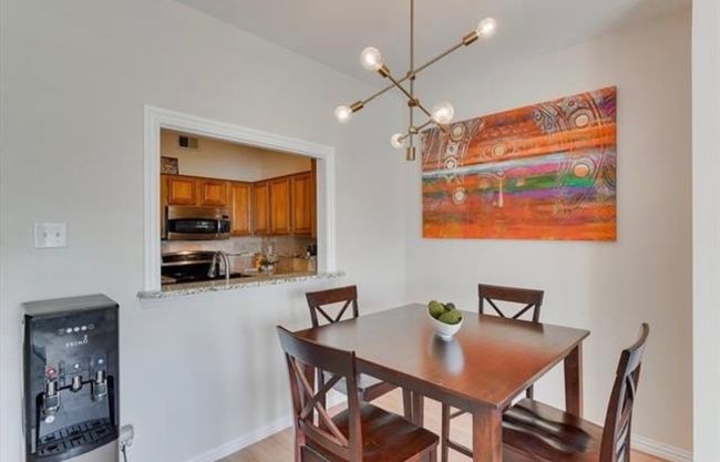 Dining room featuring a chandelier and light wood-style flooring | Image 8