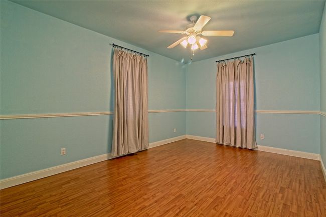 Unfurnished room featuring wood finished floors and ceiling fan | Image 24