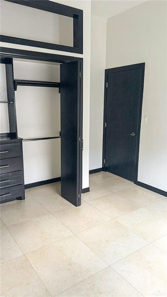 Spacious closet on secondary bedroom with built ins. | Image 12