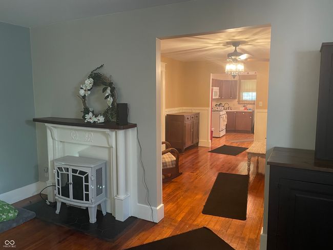 living area with wood finished floors, a ceiling fan, looking towards the DR and Kitchen | Image 15