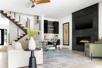 Living room featuring a large fireplace, sink, and ceiling fan | Image 3