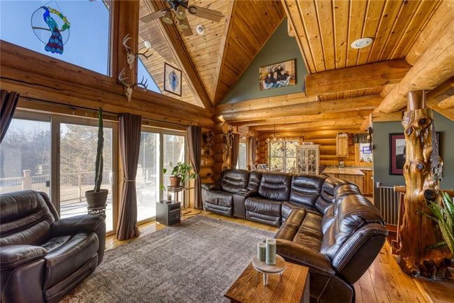 Living room with hardwood / wood-style floors, high vaulted ceiling, wood ceiling, and a ceiling fan | Image 8