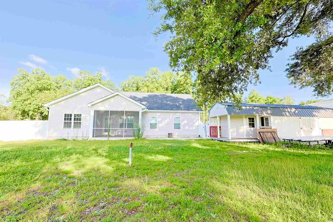 Back of property featuring a sunroom and an outbuilding | Image 29