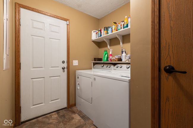laundry area featuring independent washer and dryer, laundry area, and a textured ceiling | Image 40