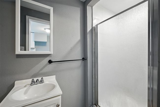 Bathroom featuring a shower stall and vanity | Image 18