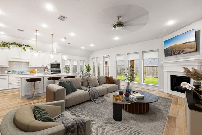 Gather the family and guests together in your lovely living room! Featuring recessed lighting, dark stained ceiling fan, neutral paint, gorgeous wood like tile floors and large windows that provide plenty of natural lighting throughout the day. *virtual staged* | Image 4