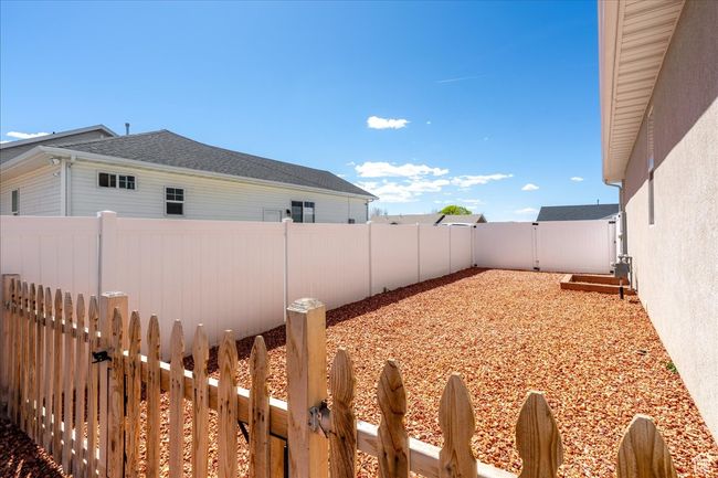 View of yard featuring a fenced backyard and a gate | Image 56