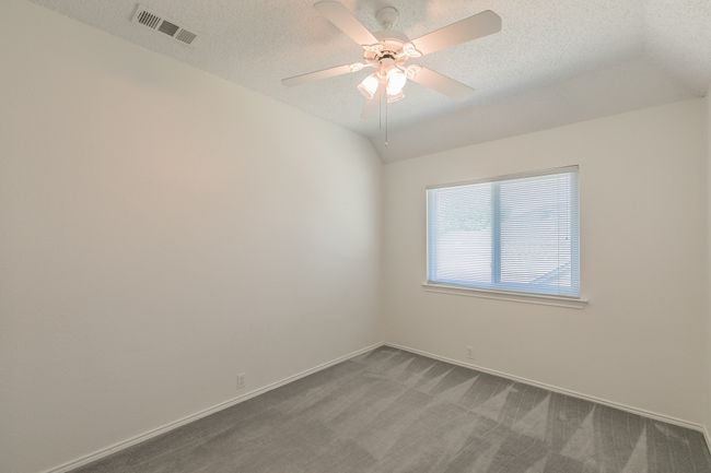 Carpeted spare room with baseboards, visible vents, a textured ceiling, and ceiling fan | Image 20