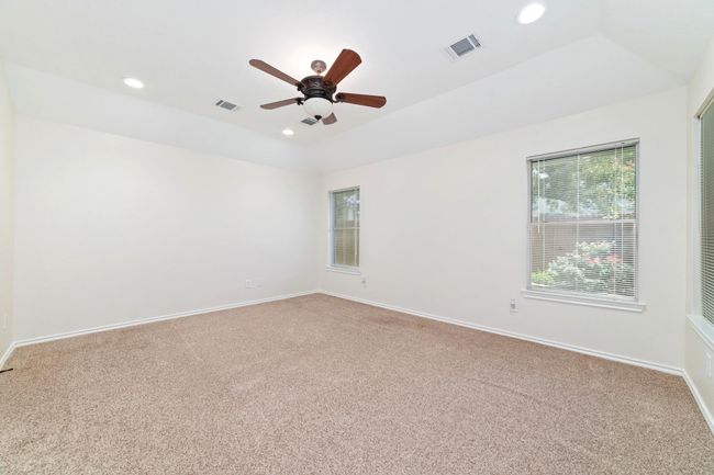 Bright and spacious primary bedroom meets a cozy backyard oasis — your perfect blend of comfort and tranquility. | Image 20