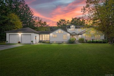 View of front facade featuring a garage and a lawn | Image 1