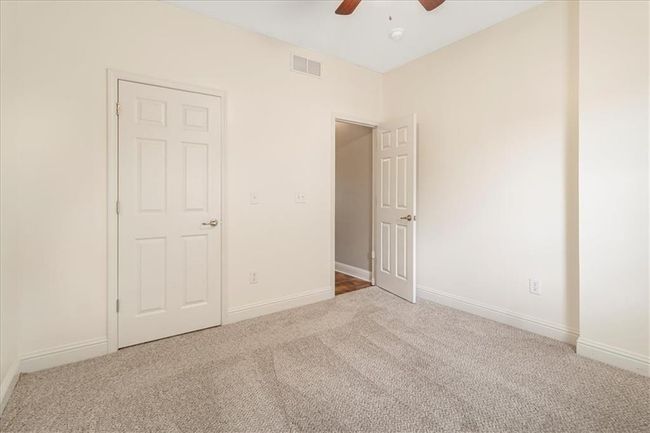 Unfurnished bedroom featuring baseboards, carpet flooring, and visible vents | Image 25